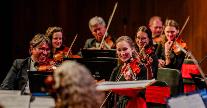 Violin Smiling Oct 2024 CWSO violins smiling during a concert.